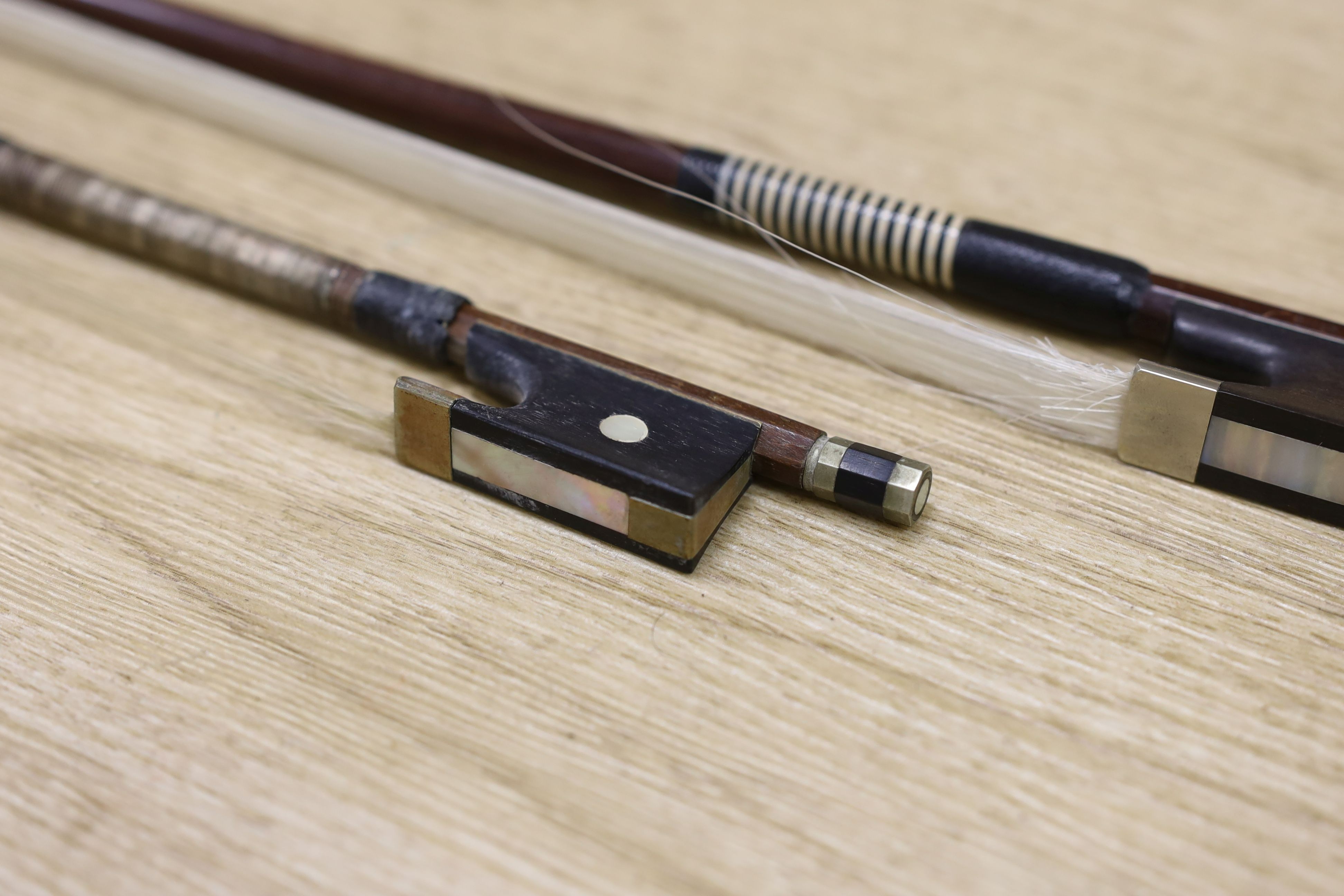 Two violin bows, signed Erich Steiner and Tourte, 73 cms long.